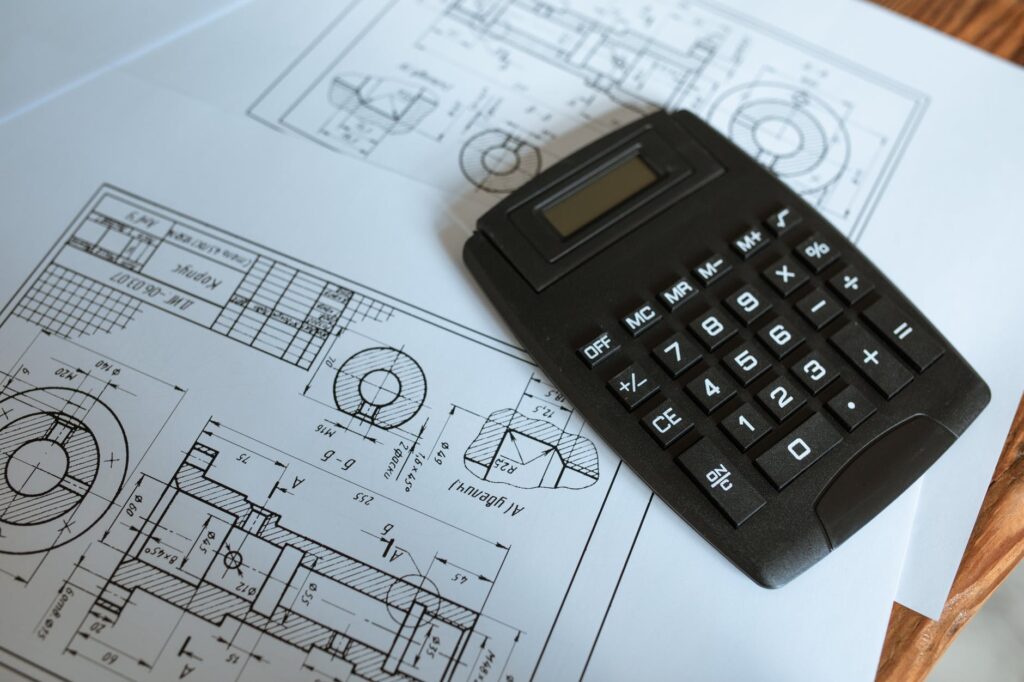 black calculator on blueprints