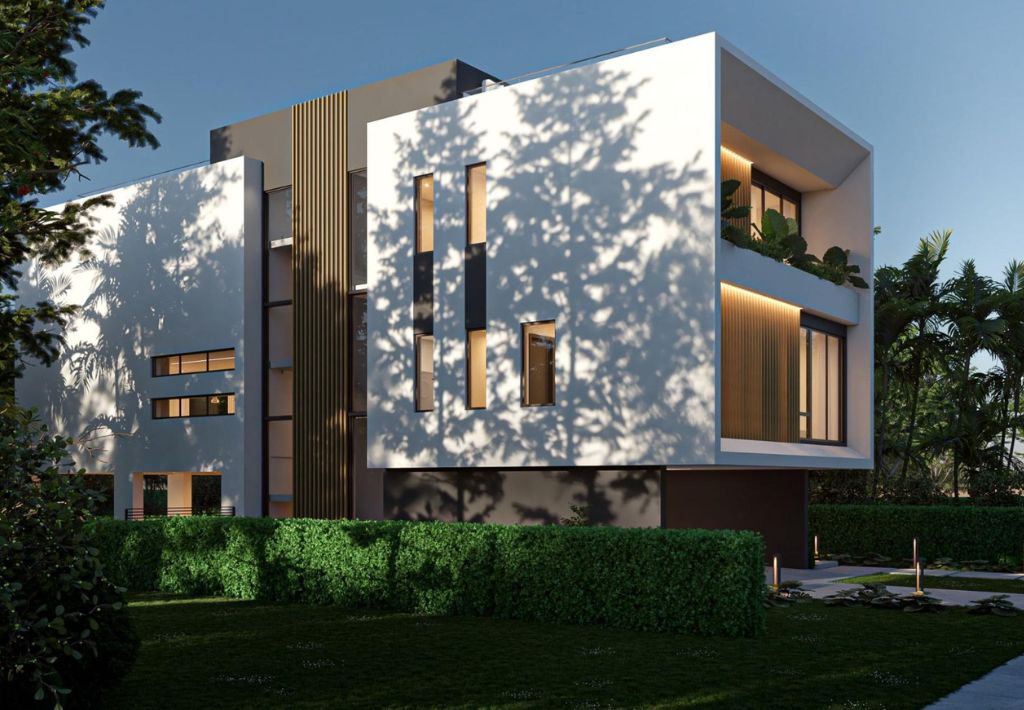 Modern three-story house with white exterior, large windows, and geometric design offers resort style living, surrounded by green hedges and trees casting shadows on the building, under a clear blue sky.