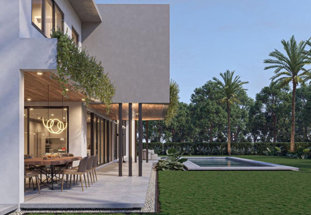 Modern house with large windows, a patio dining area, and hanging decorative lights. Enjoy resort style living with a lush green lawn, rectangular pool, and tall palm trees in the landscaped backyard under a clear sky.